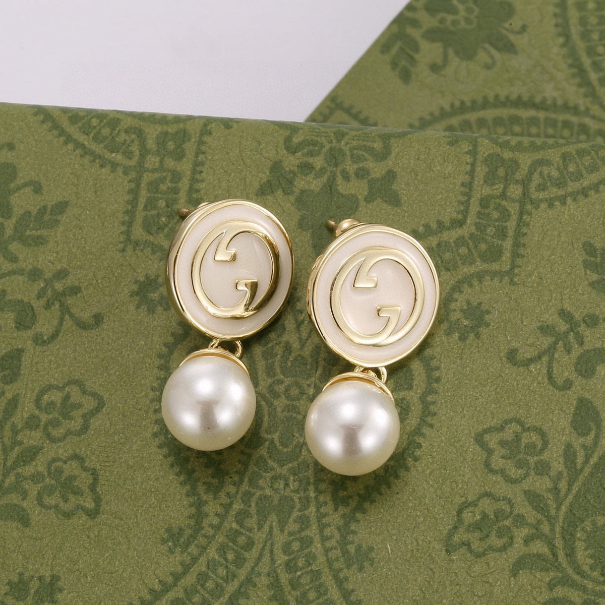 Martin Graham stud earrings in polished metal-tone – close-up detail