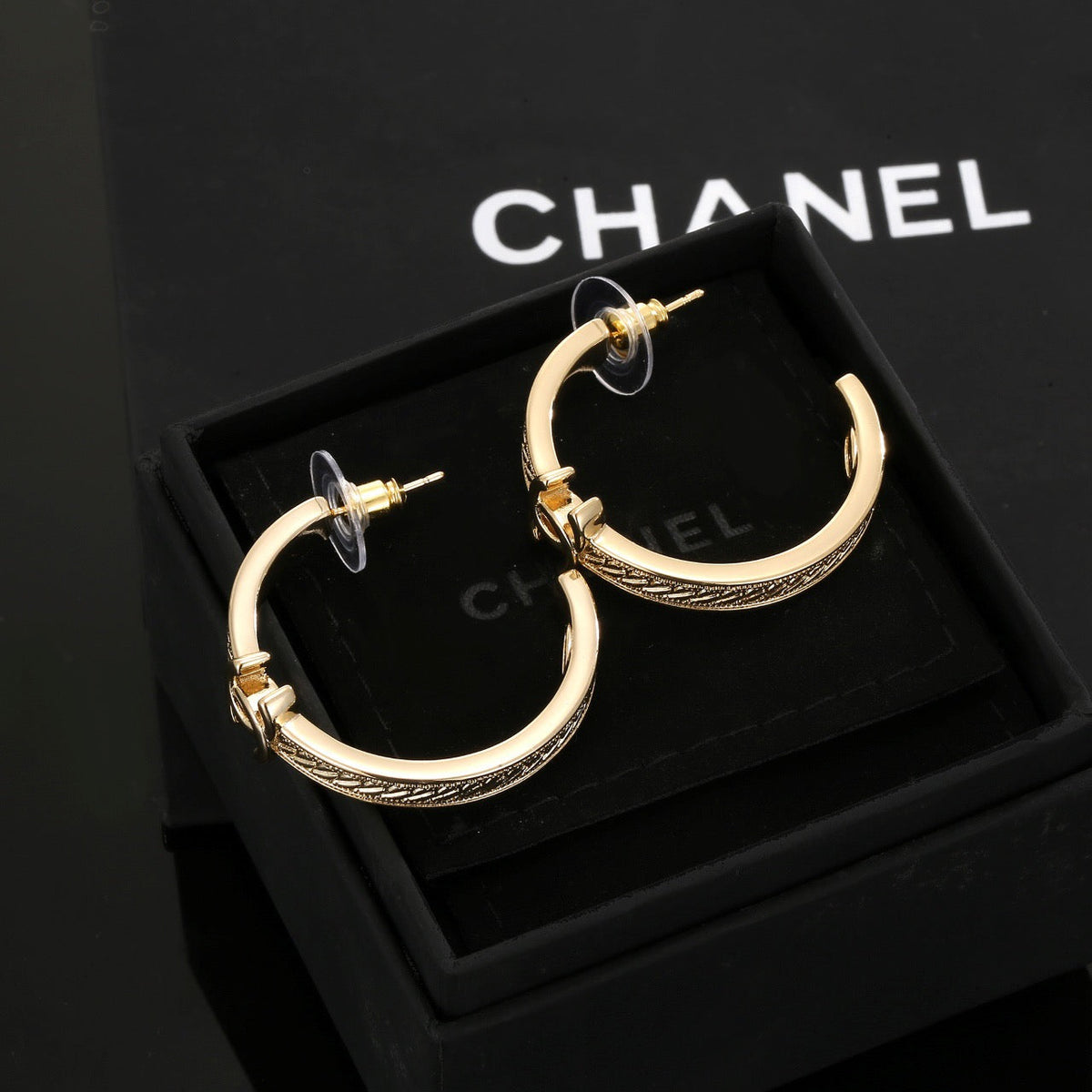 Martin Graham stud earrings in polished metal-tone – detail view