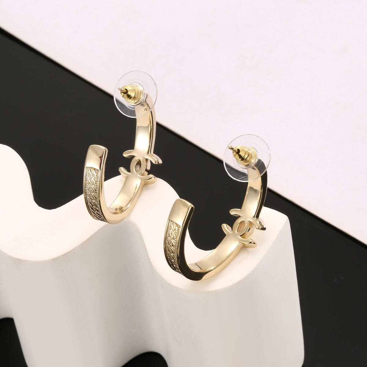 Martin Graham stud earrings in polished metal-tone – close-up detail