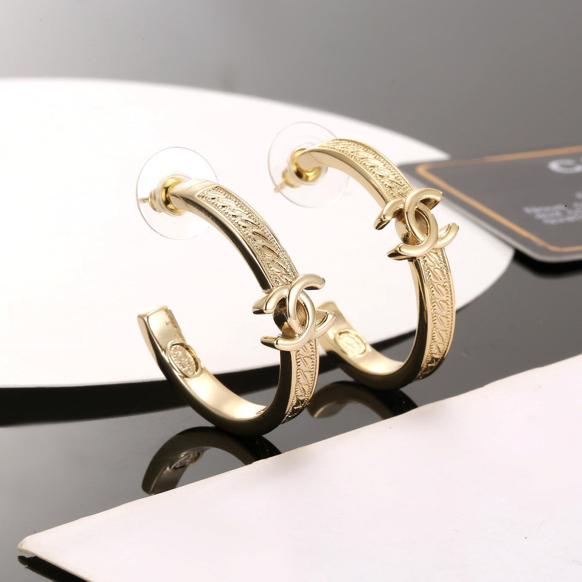 Martin Graham stud earrings in polished metal-tone – side detail