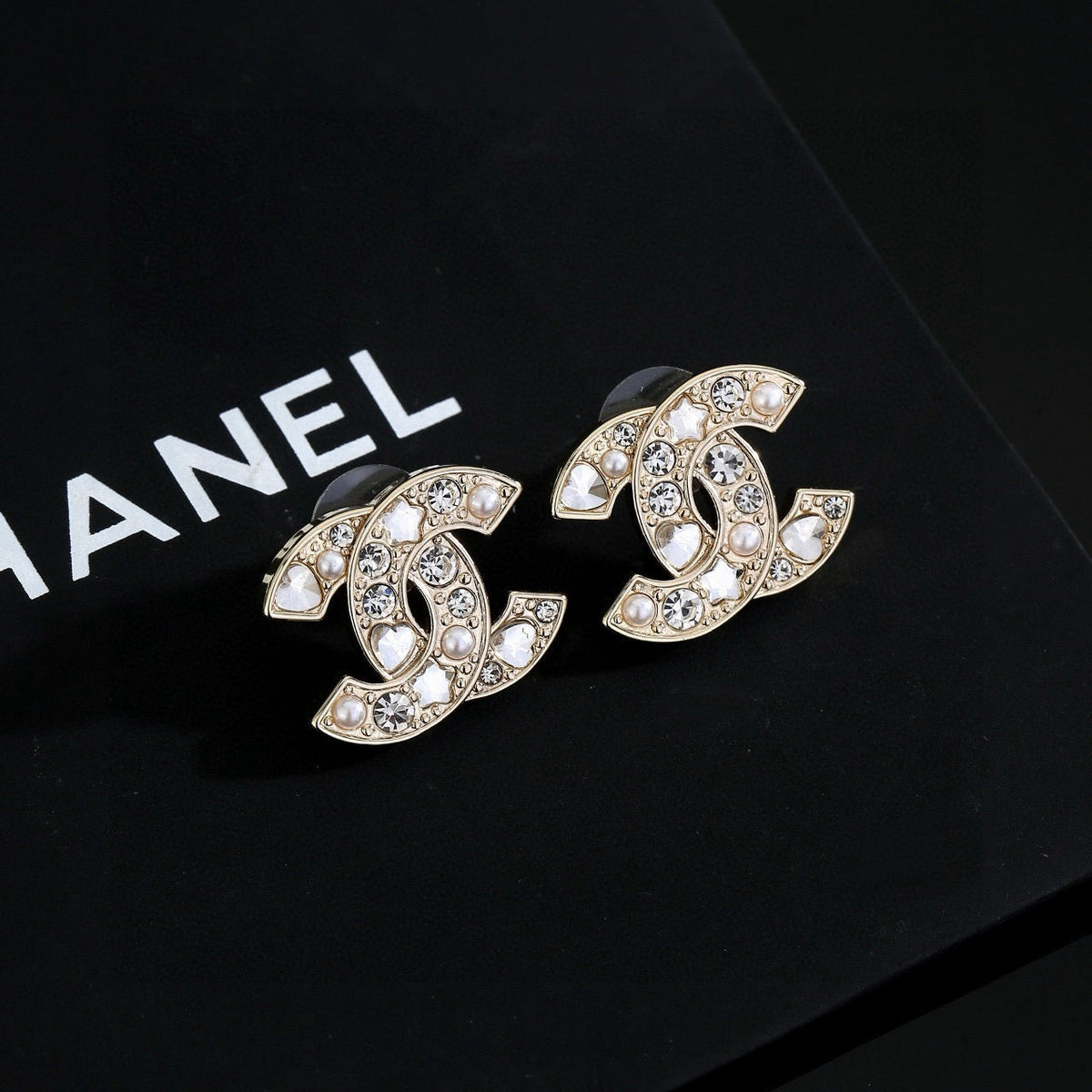 Martin Graham stud earrings in polished metal-tone – detail view