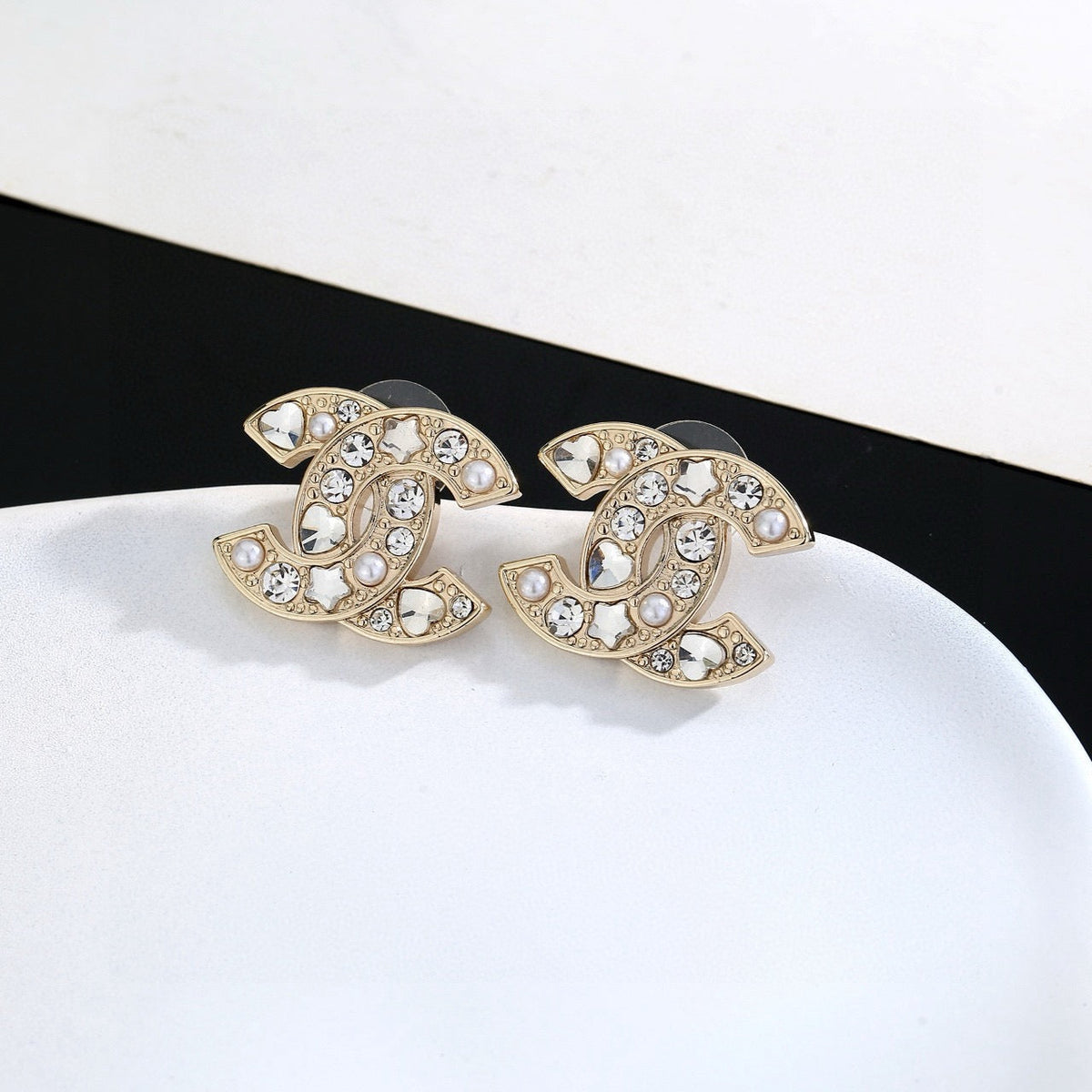Martin Graham stud earrings in polished metal-tone – close-up detail