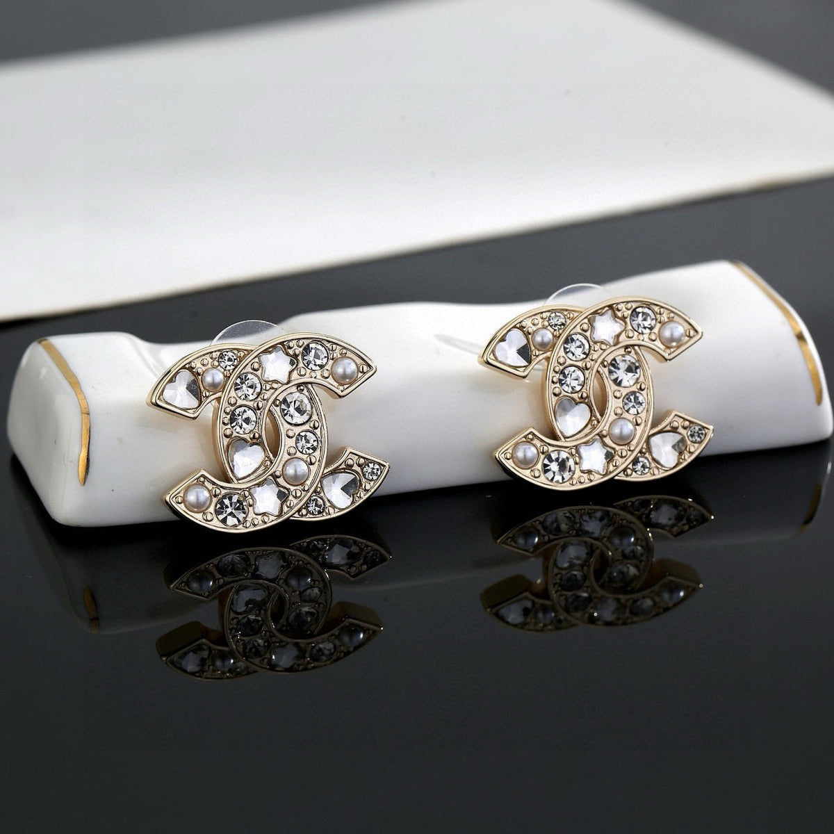 Martin Graham stud earrings in polished metal-tone – side detail