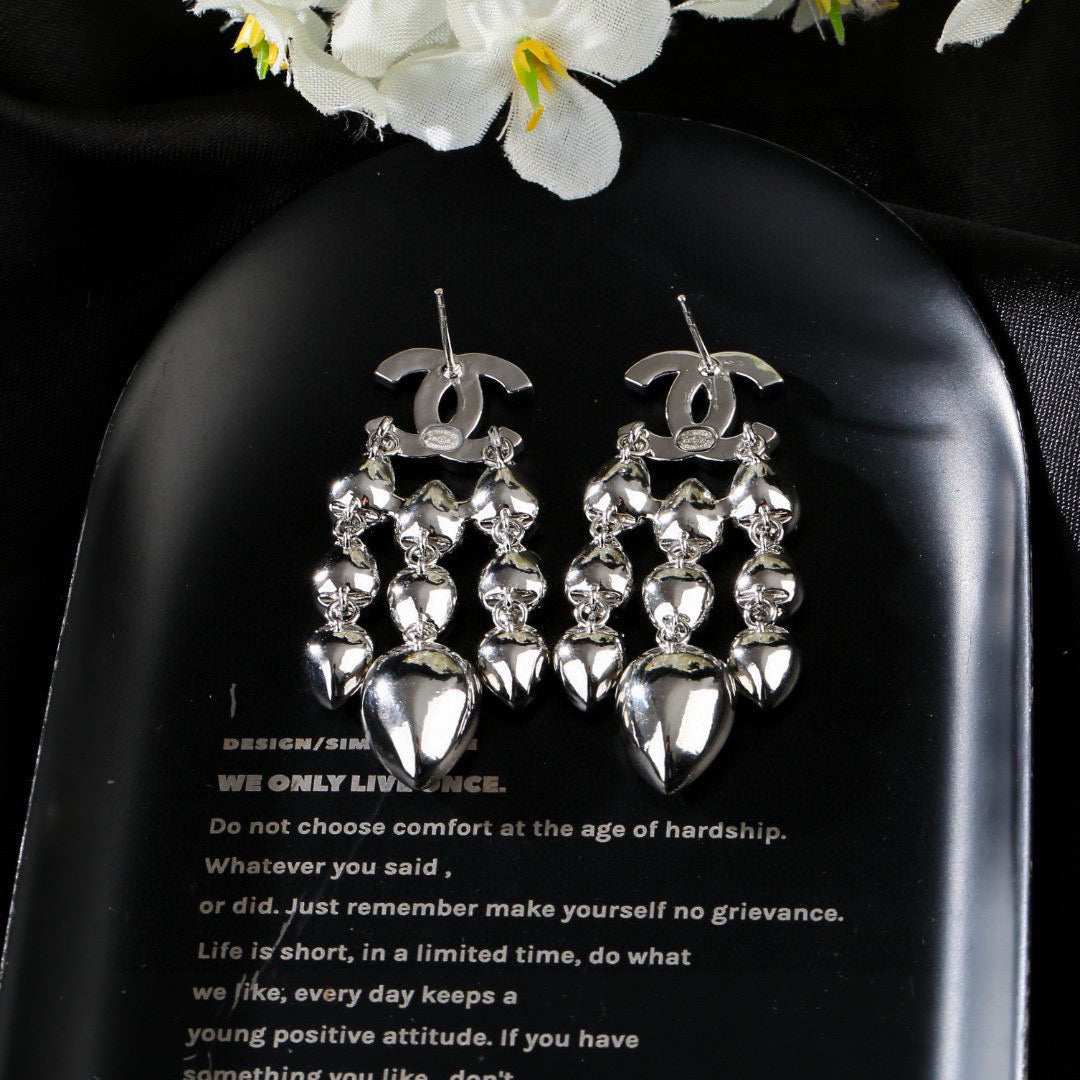 Martin Graham stud earrings in polished metal-tone – close-up detail