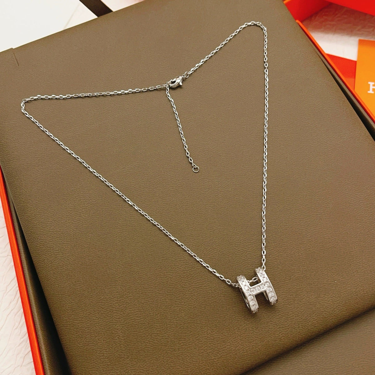 Martin Graham pendant necklace in polished metal-tone – close-up detail