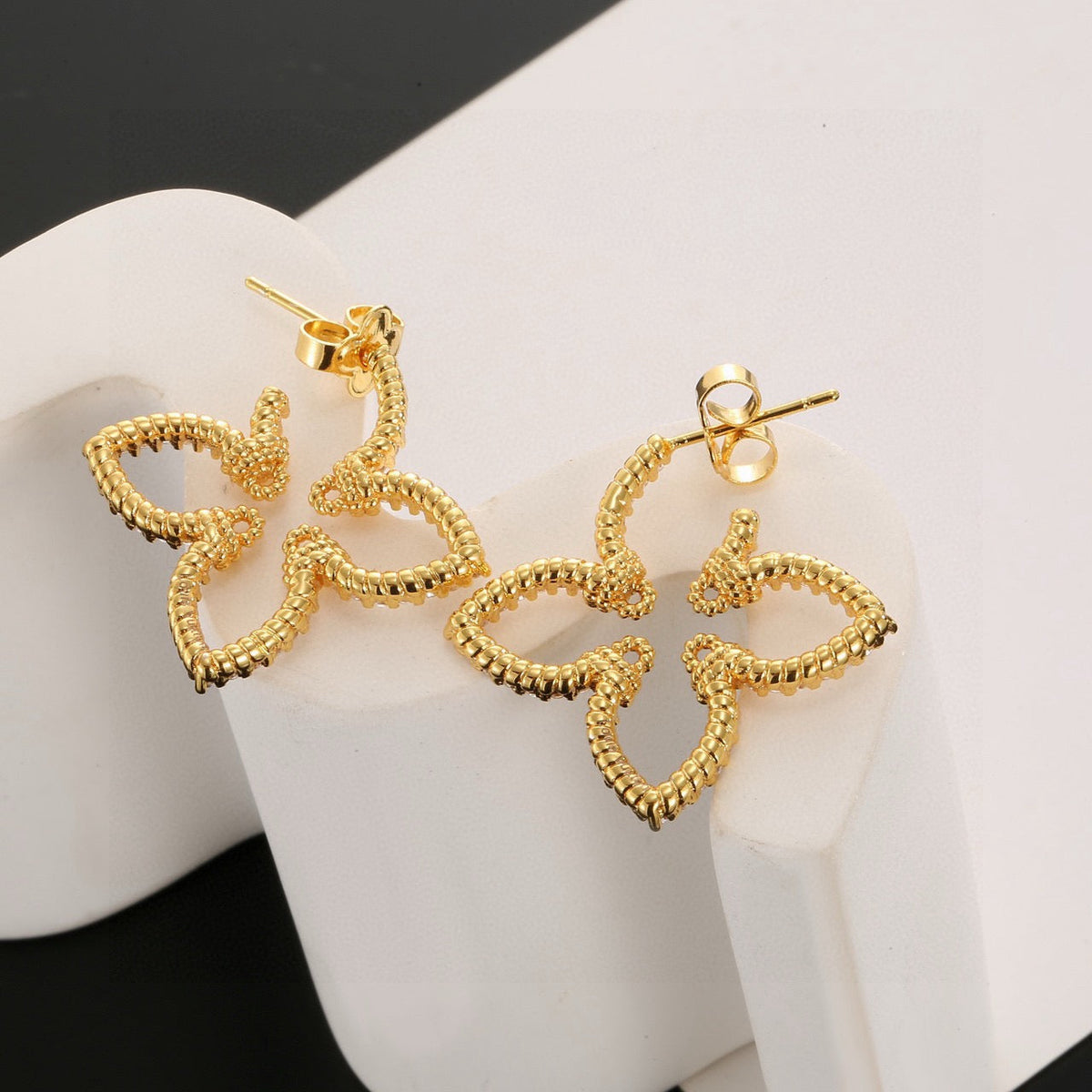 Martin Graham stud earrings in polished metal-tone – side detail