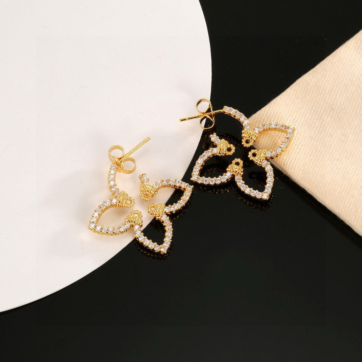 Martin Graham stud earrings in polished metal-tone – styled product view