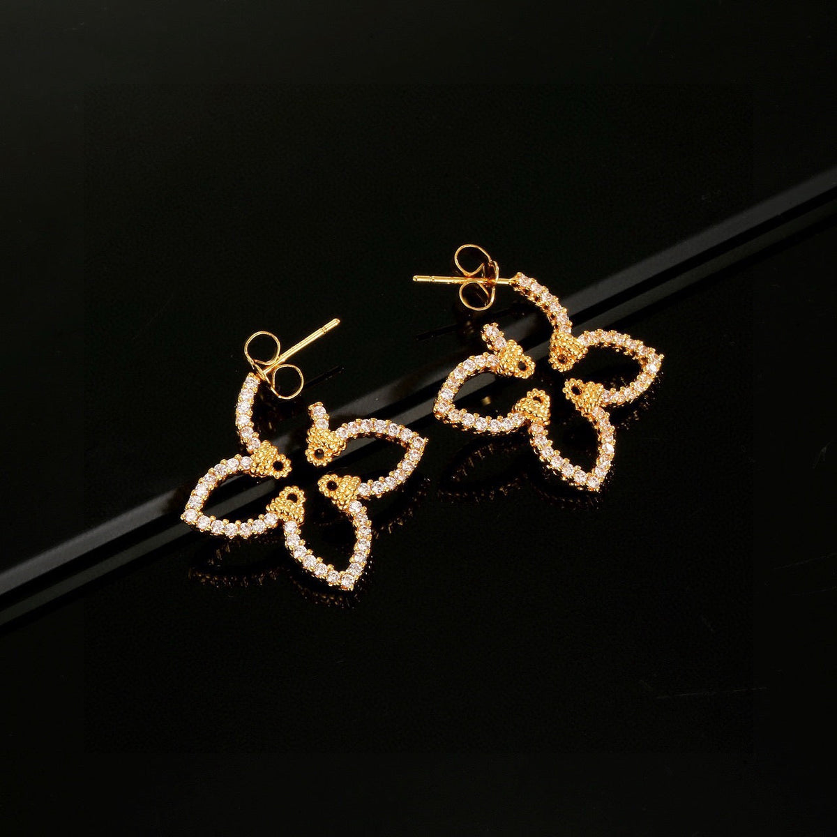 Martin Graham stud earrings in polished metal-tone – front product view