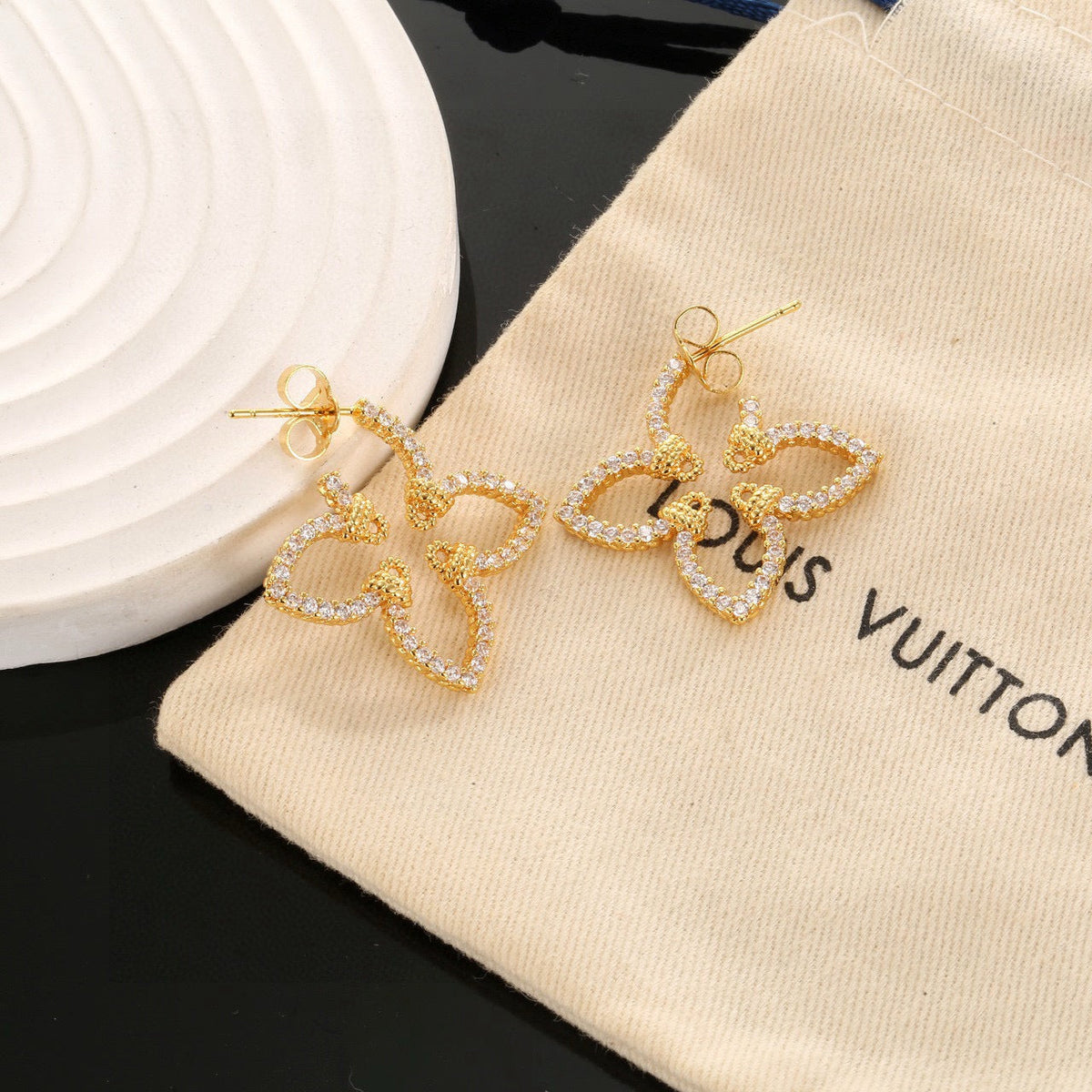 Martin Graham stud earrings in polished metal-tone – close-up detail