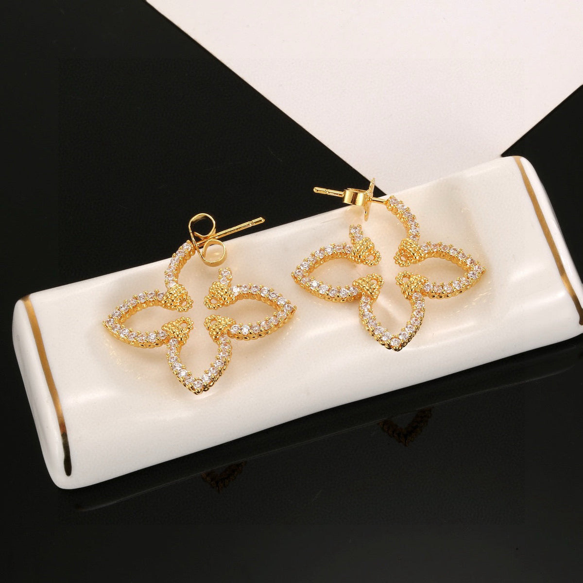 Martin Graham stud earrings in polished metal-tone – detail view