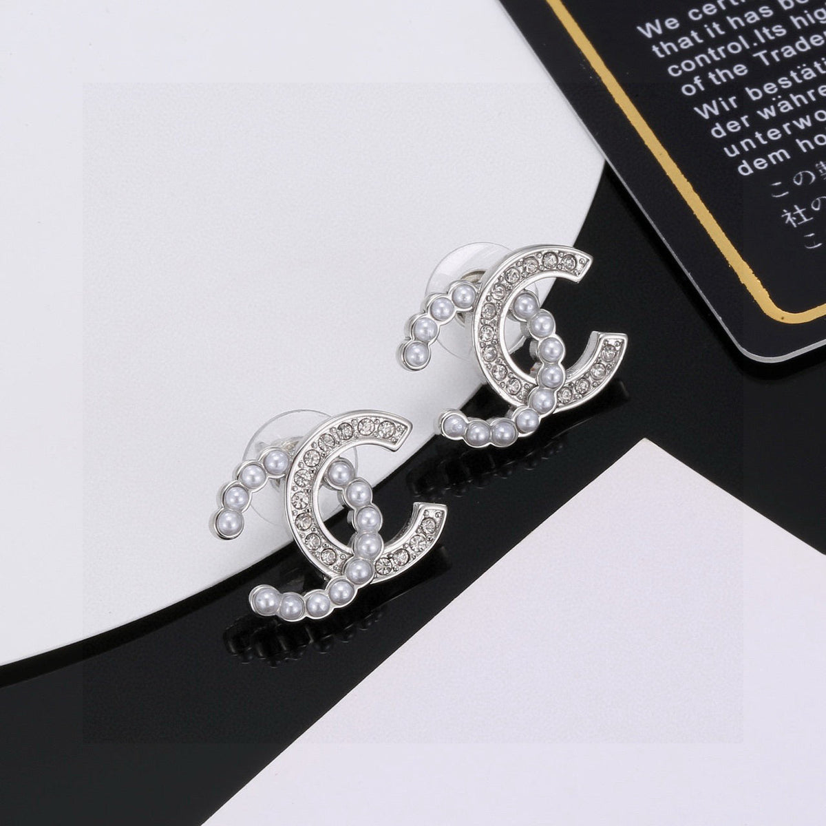 Martin Graham stud earrings in polished metal-tone – close-up detail