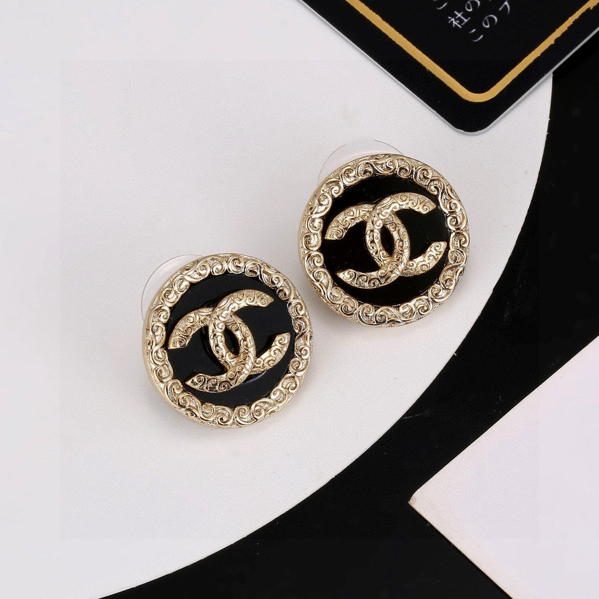 Martin Graham stud earrings in polished metal-tone – detail view
