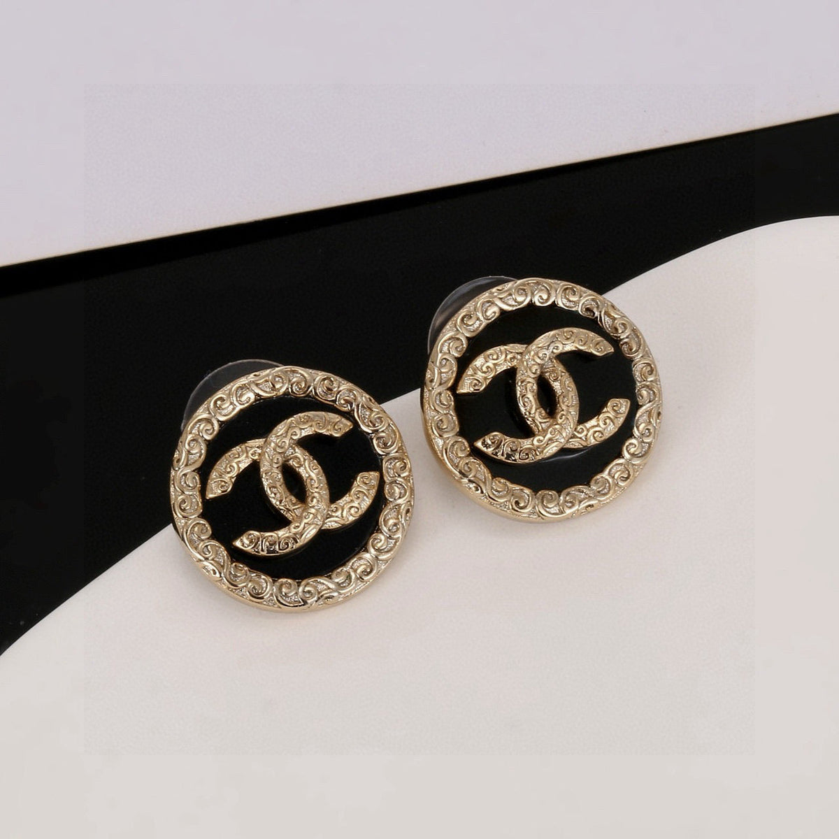 Martin Graham stud earrings in polished metal-tone – close-up detail
