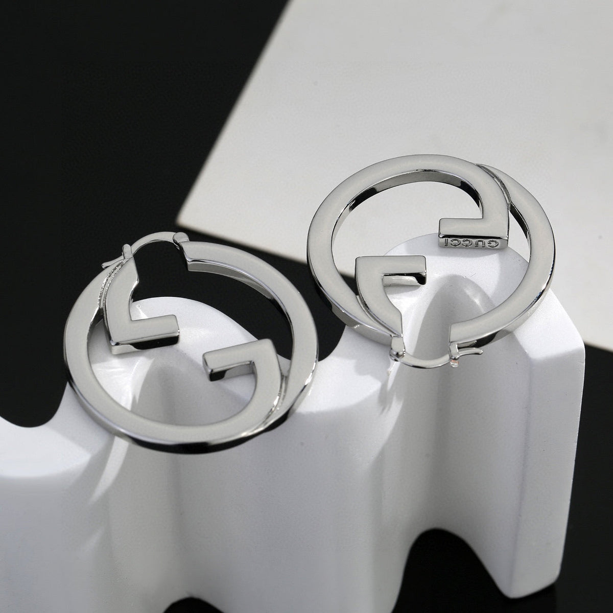 Martin Graham stud earrings in polished metal-tone – close-up detail