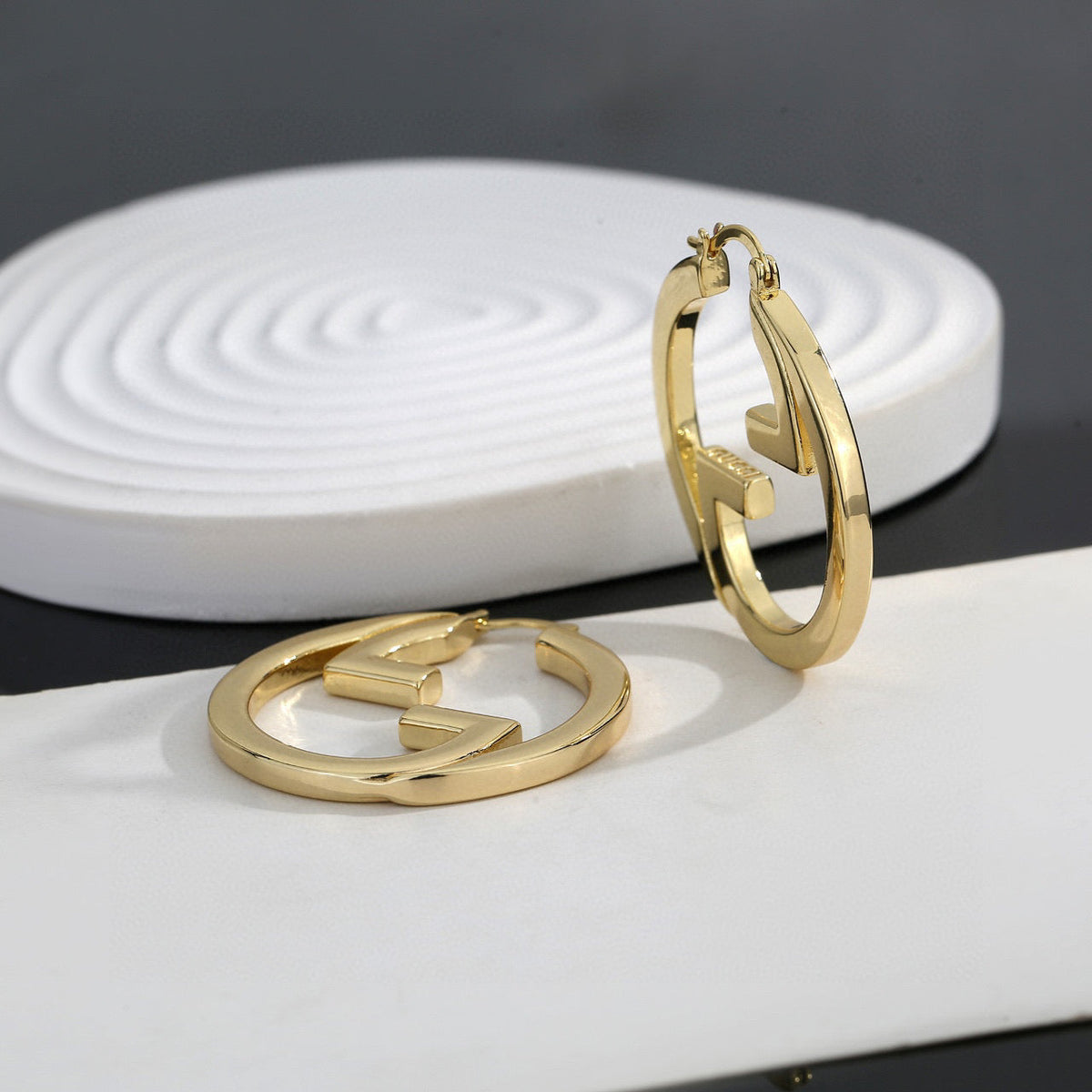 Martin Graham stud earrings in polished metal-tone – main product view