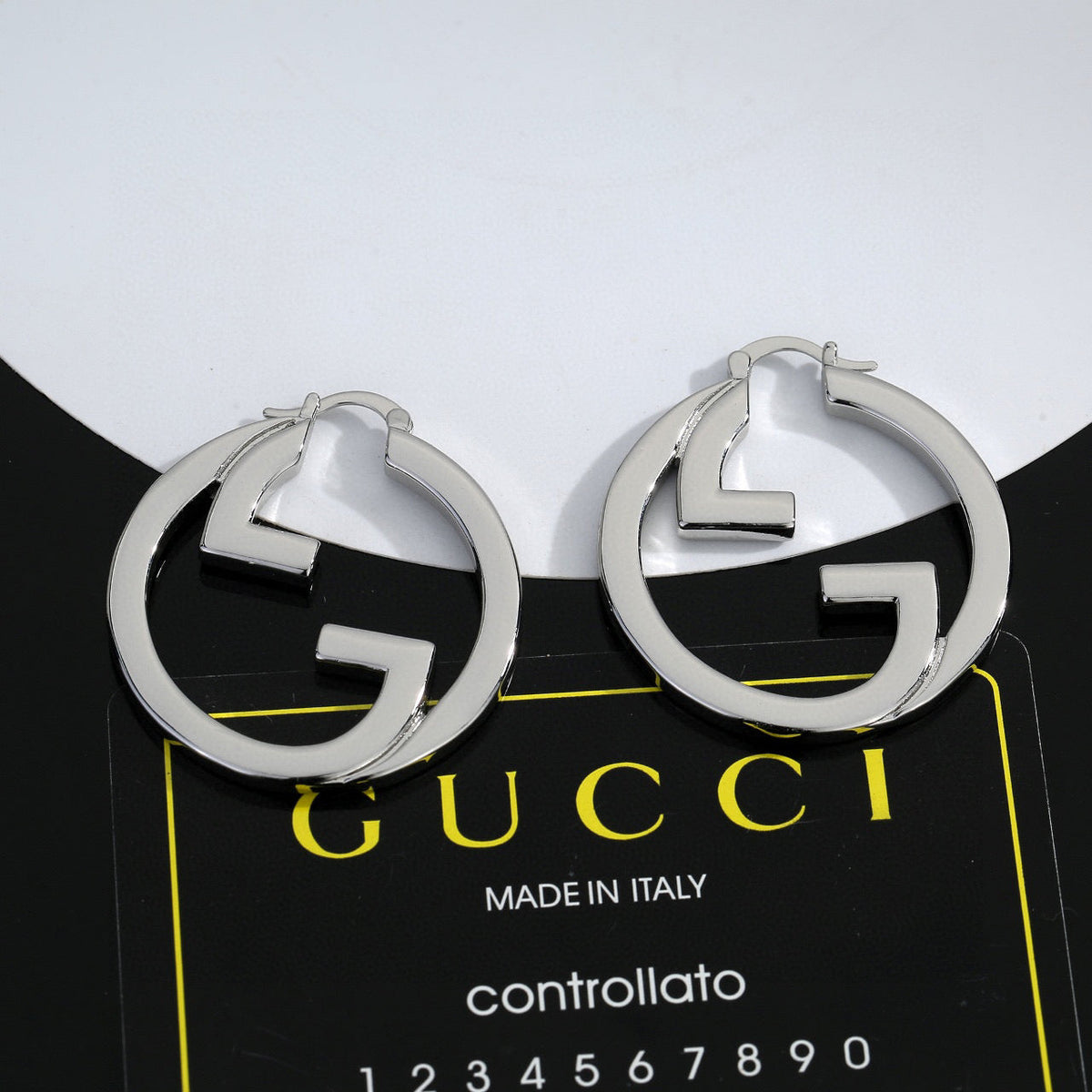 Martin Graham stud earrings in polished metal-tone – styled product view