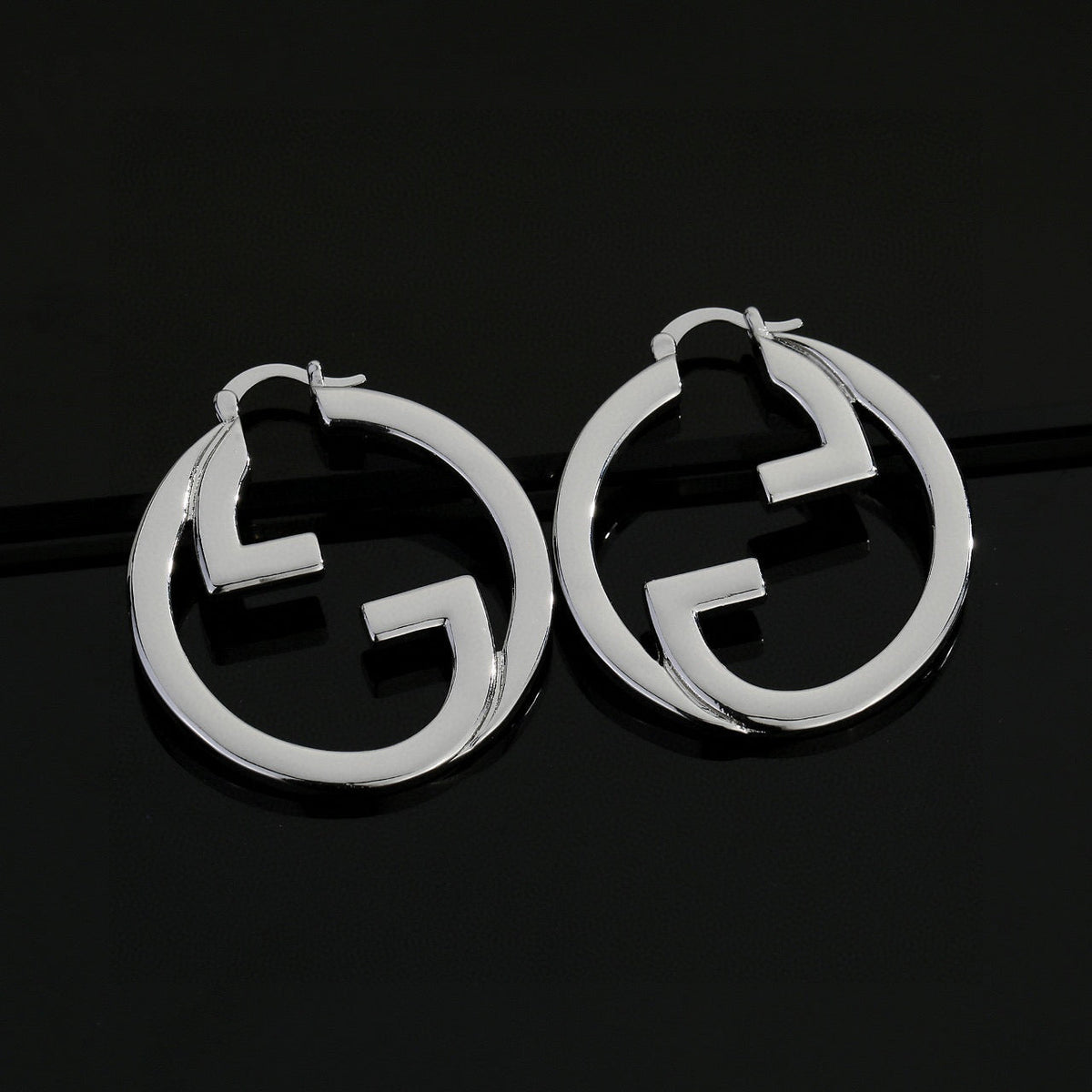 Martin Graham stud earrings in polished metal-tone – side detail