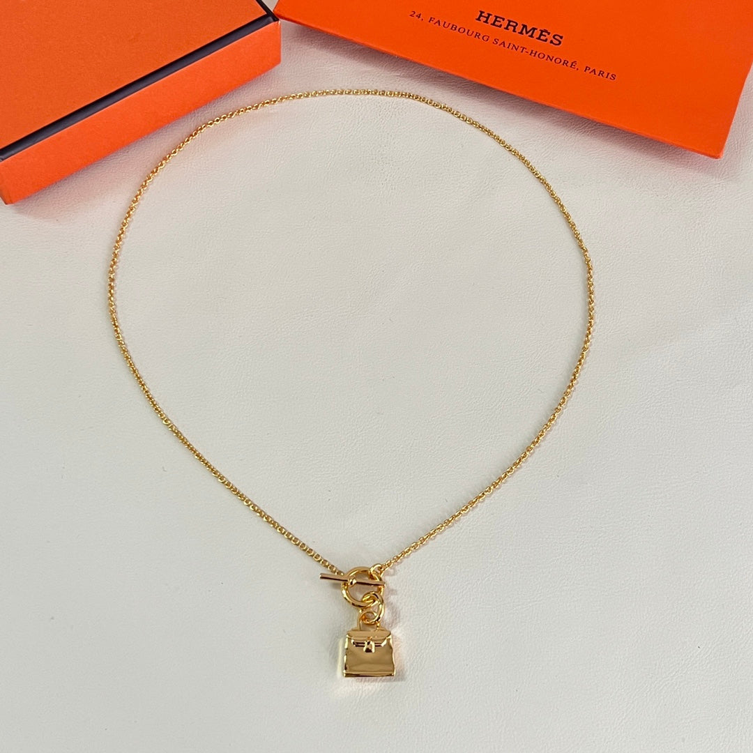 Martin Graham pendant necklace in polished metal-tone – close-up detail