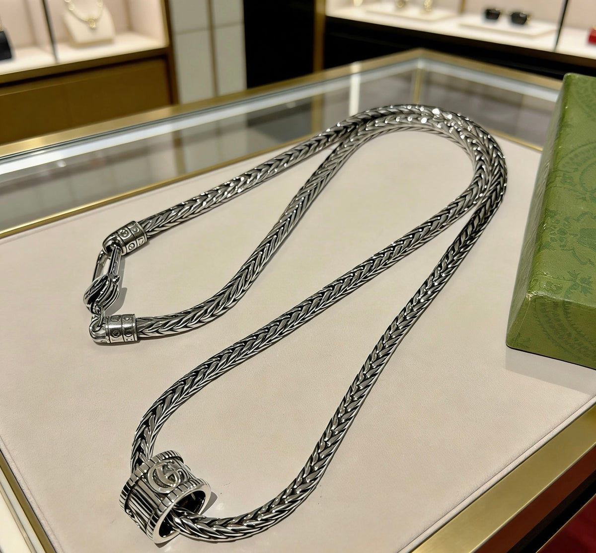 Martin Graham pendant necklace in polished metal-tone – close-up detail
