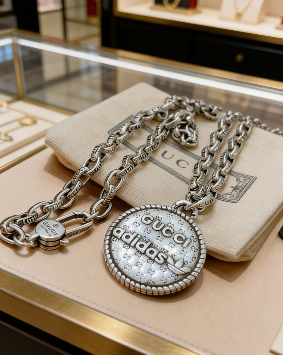 Martin Graham pendant necklace in polished metal-tone – side detail