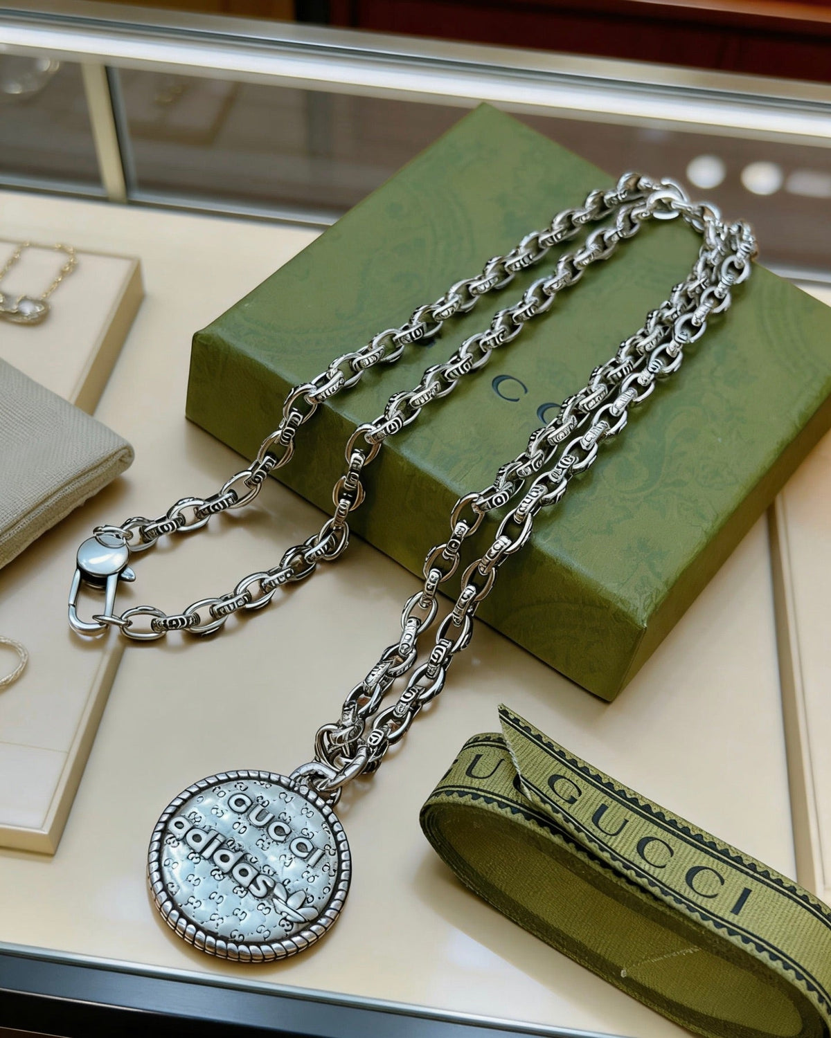 Martin Graham pendant necklace in polished metal-tone – close-up detail
