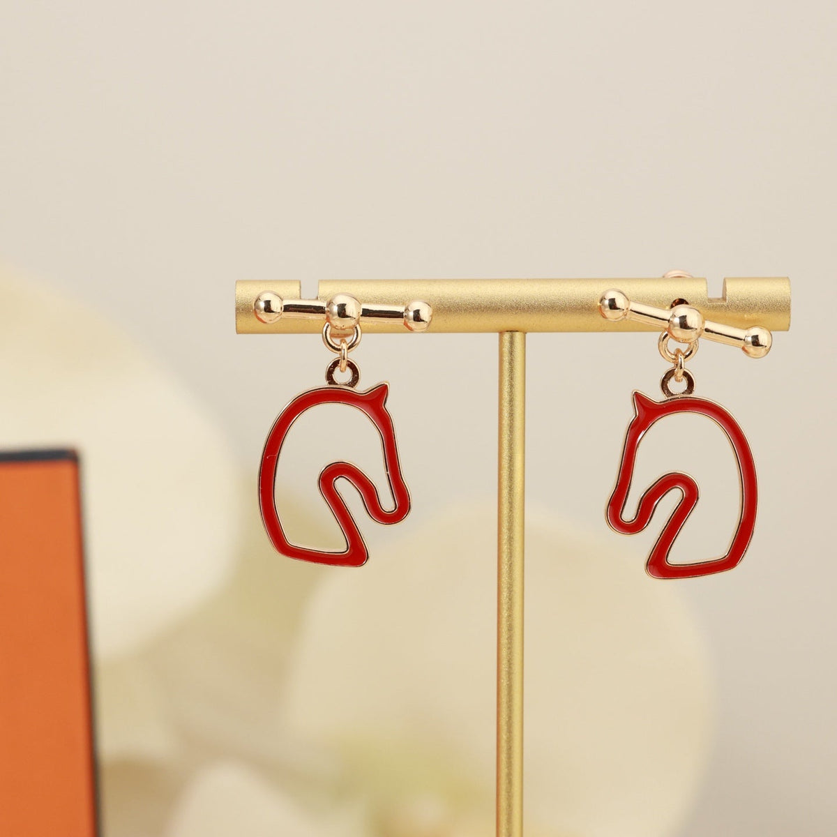 Martin Graham stud earrings in polished metal-tone – close-up detail