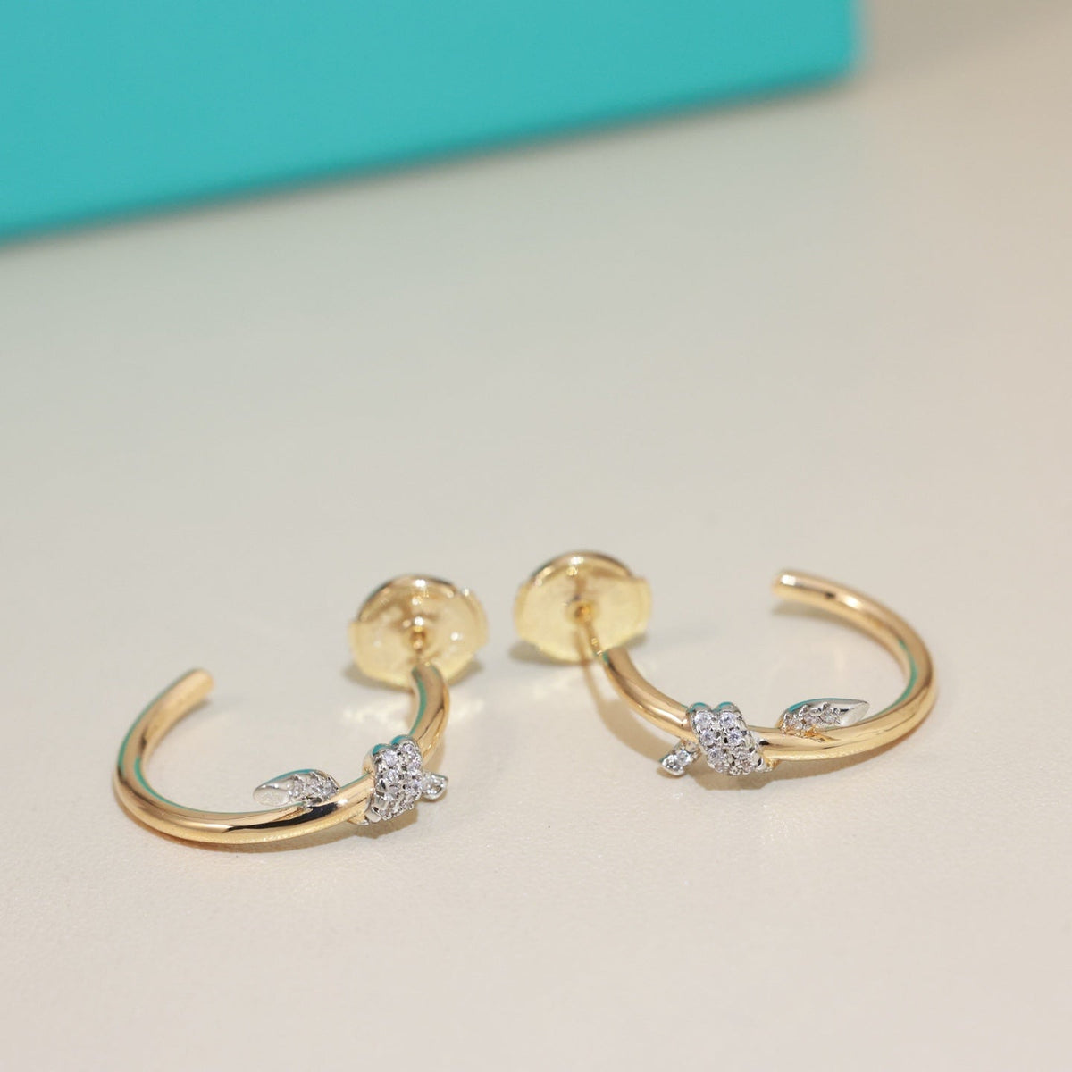 Martin Graham stud earrings in polished metal-tone – front product view