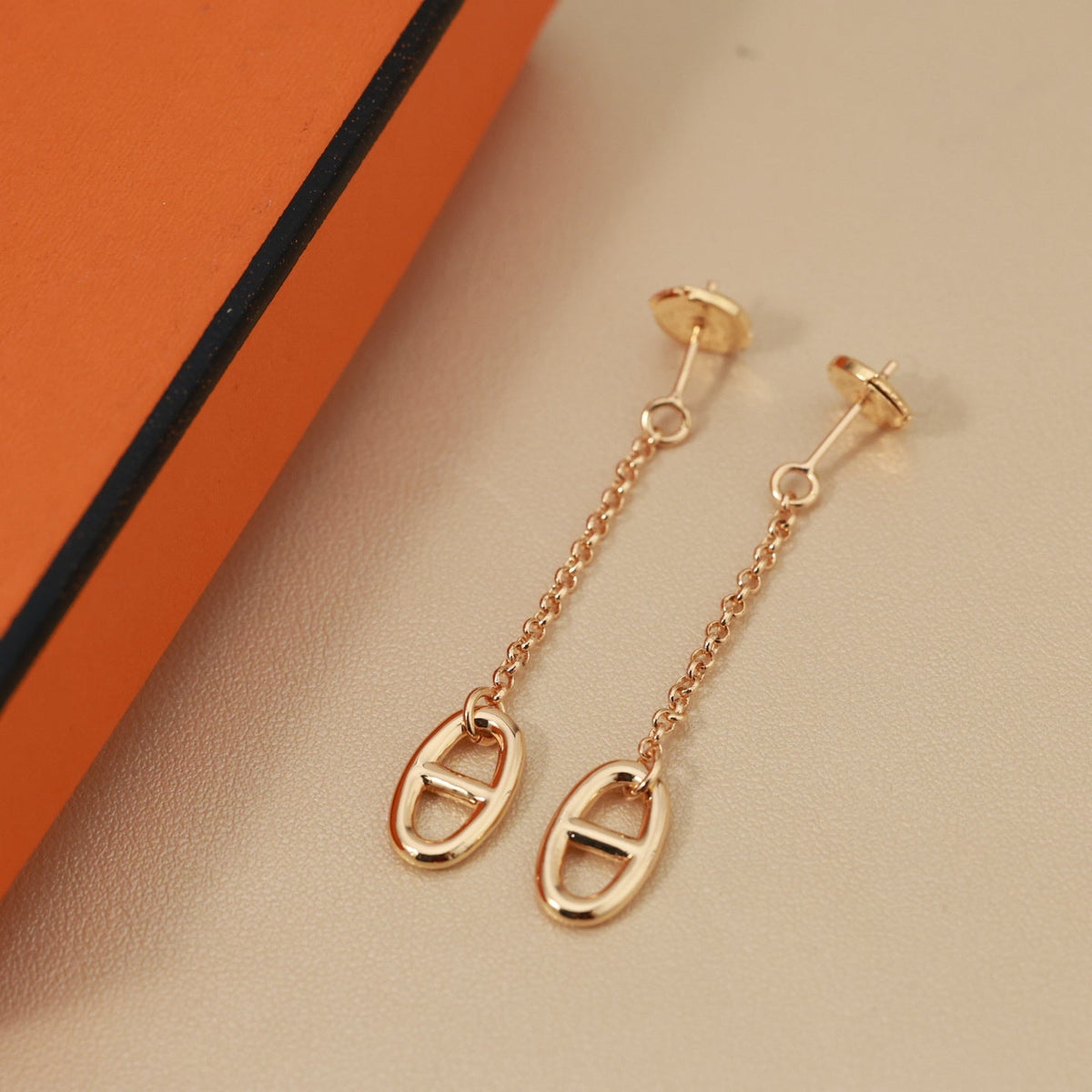 Martin Graham stud earrings in polished metal-tone – close-up detail