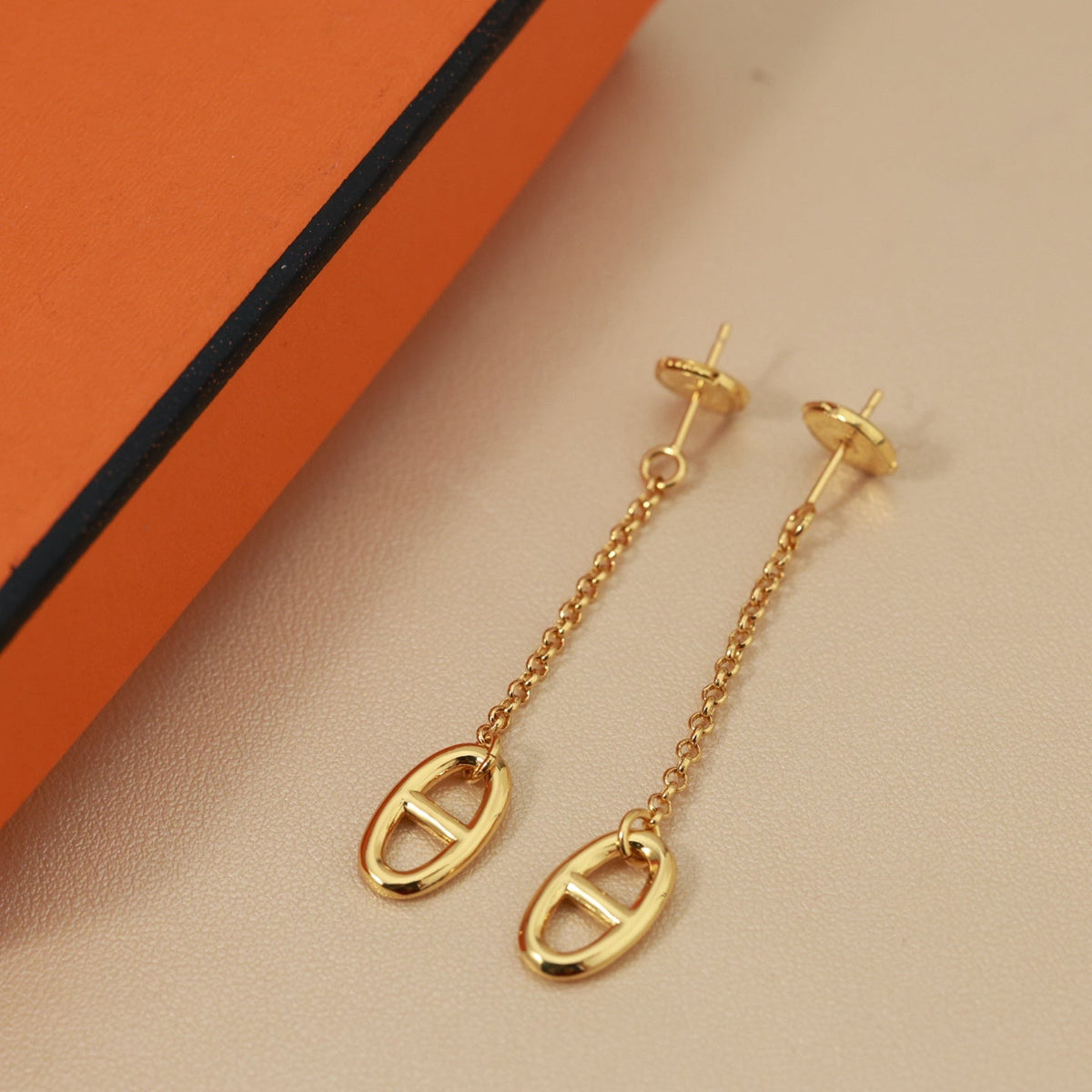 Martin Graham stud earrings in polished metal-tone – styled product view