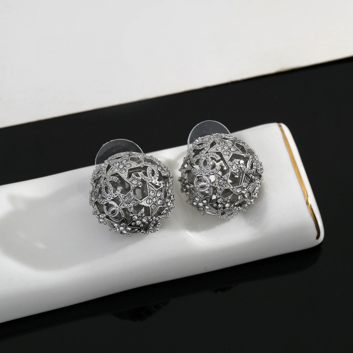 Martin Graham stud earrings in polished metal-tone – close-up detail