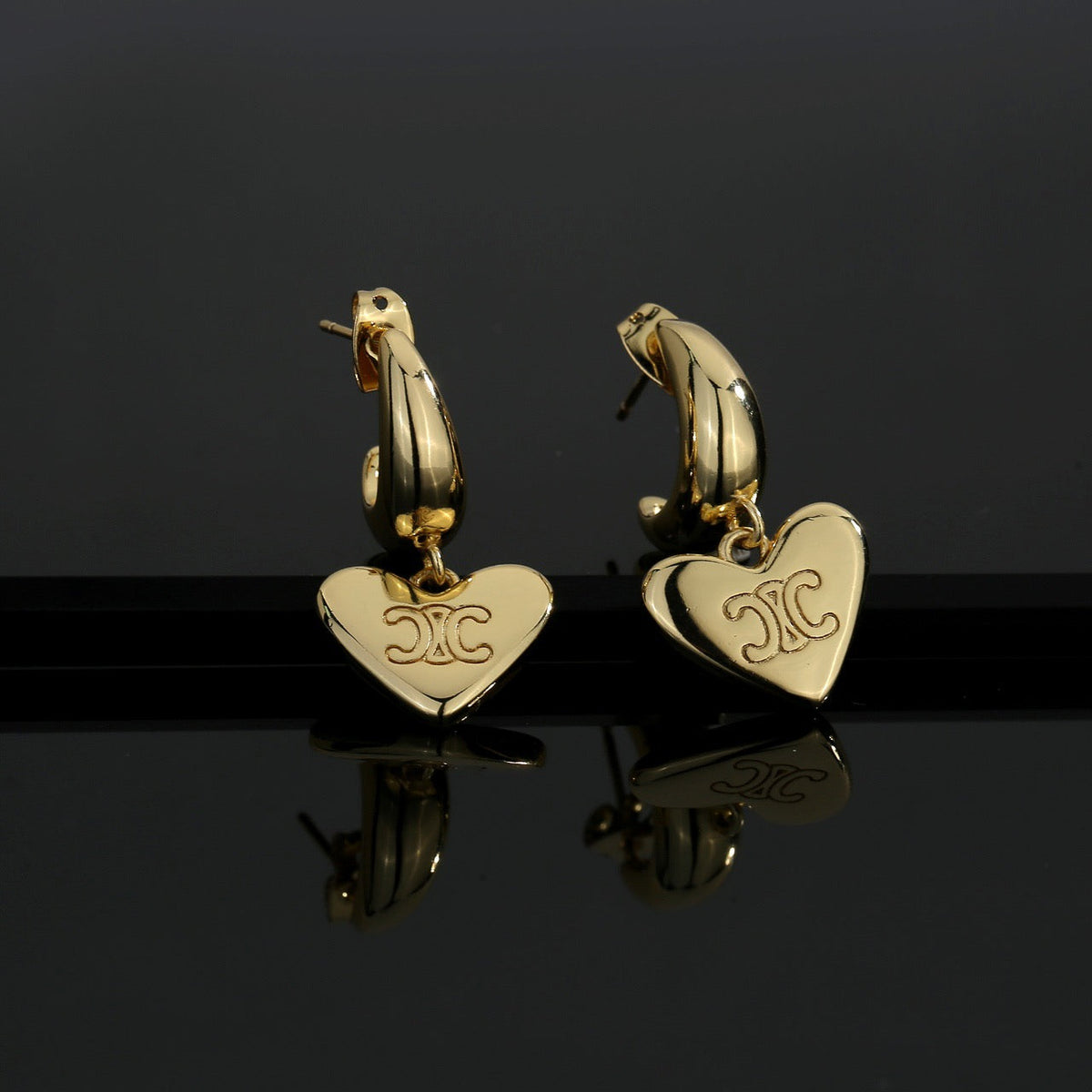 Martin Graham stud earrings in polished metal-tone