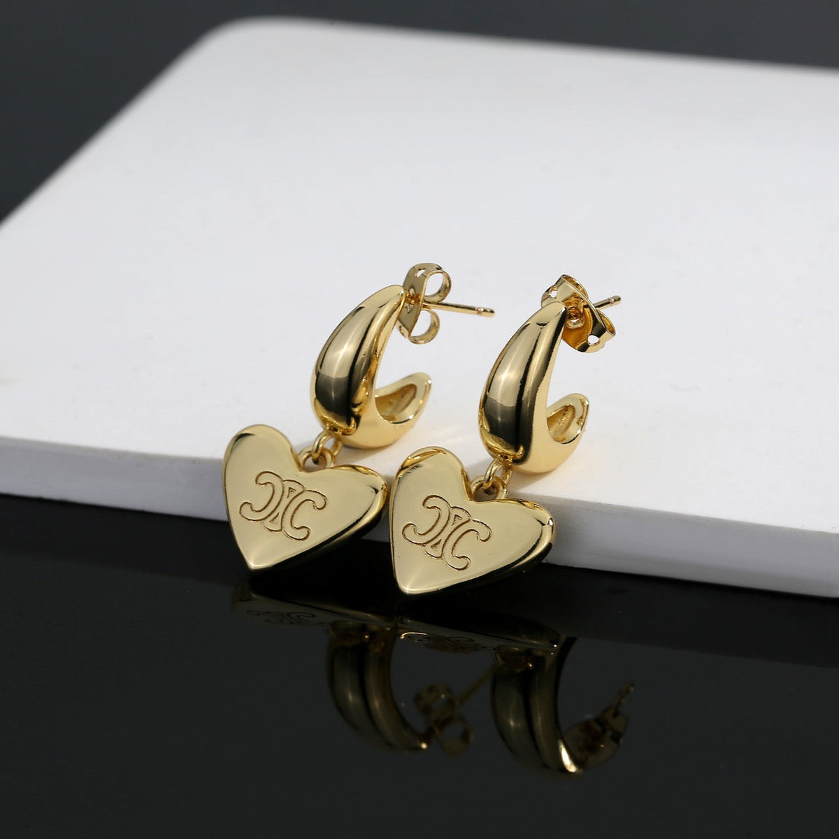 Martin Graham stud earrings in polished metal-tone – main product view