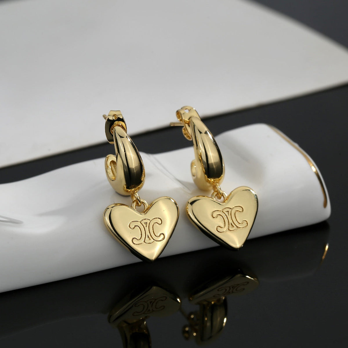 Martin Graham stud earrings in polished metal-tone – side detail