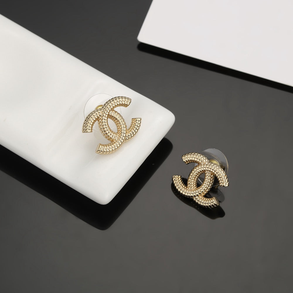 Martin Graham stud earrings in polished metal-tone – styled product view
