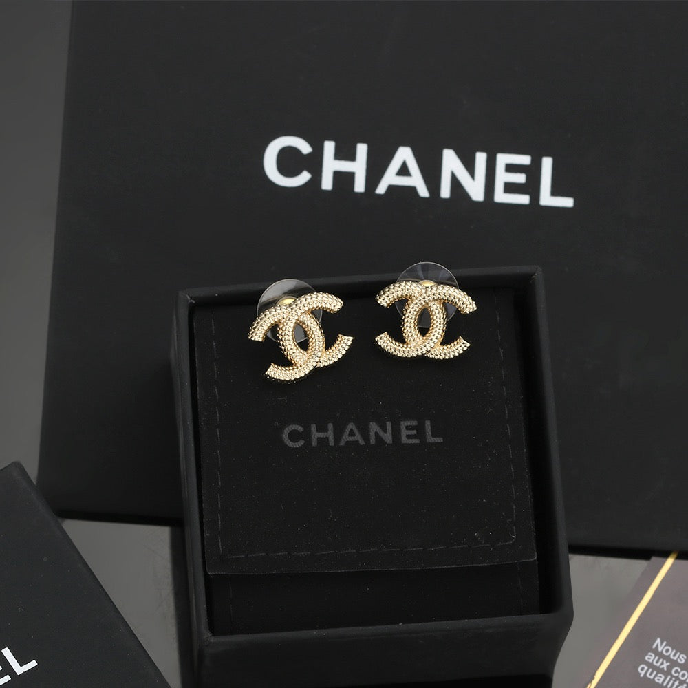 Martin Graham stud earrings in polished metal-tone – close-up detail