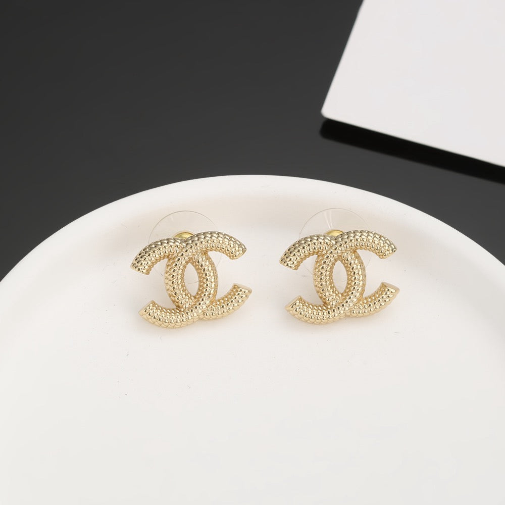 Martin Graham stud earrings in polished metal-tone – detail view