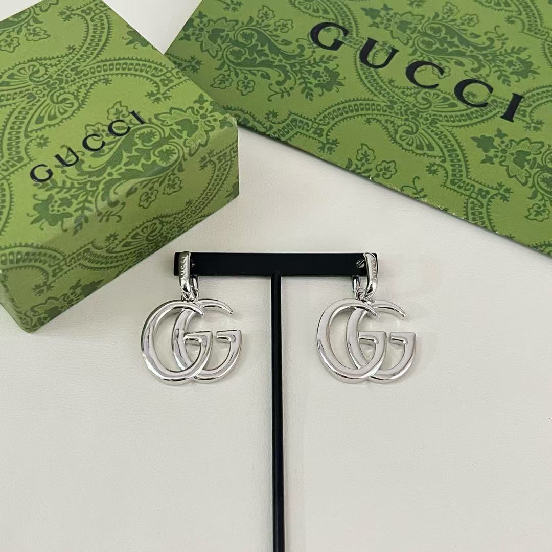 Martin Graham stud earrings in polished metal-tone – styled product view