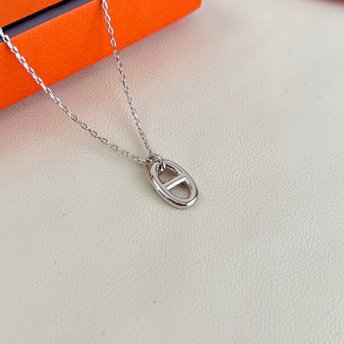 Martin Graham pendant necklace in polished metal-tone – close-up detail