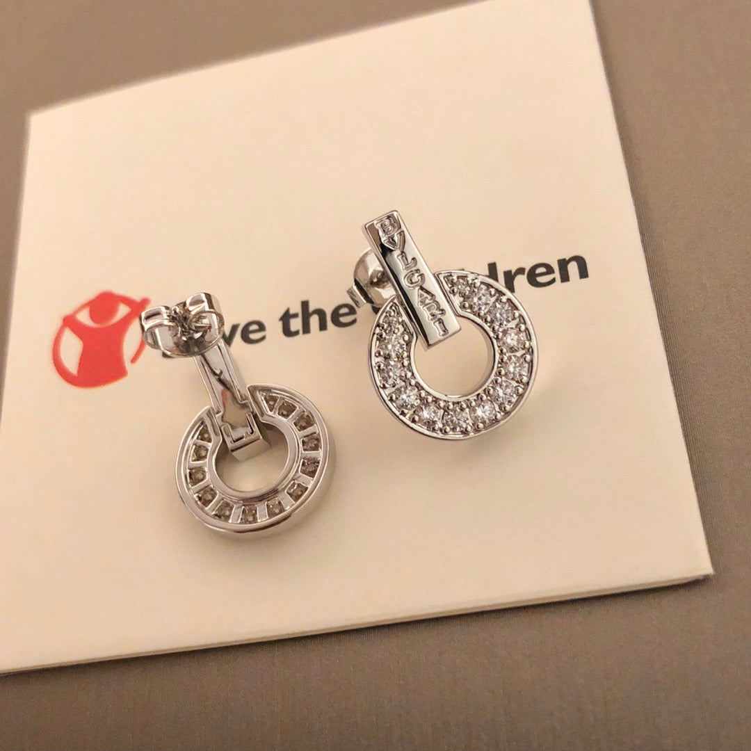 Martin Graham stud earrings in polished metal-tone – close-up detail