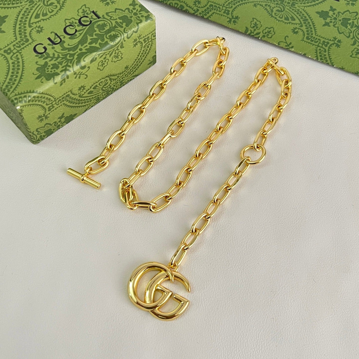 Martin Graham pendant necklace in polished metal-tone – side detail
