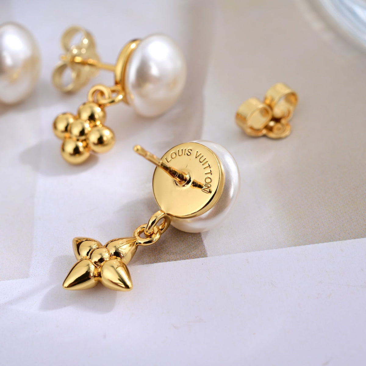 Martin Graham stud earrings in polished metal-tone – side detail