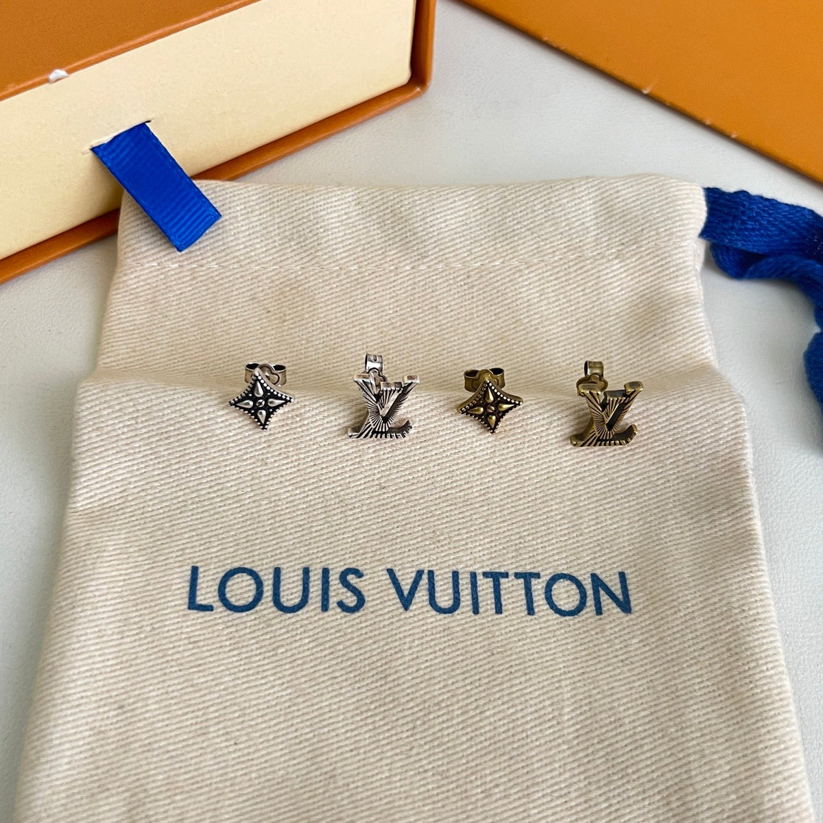 Martin Graham stud earrings in polished metal-tone – styled product view