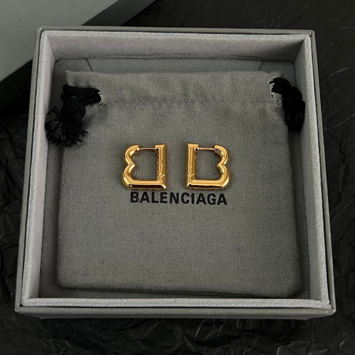 Martin Graham earrings in polished metal-tone – front product view