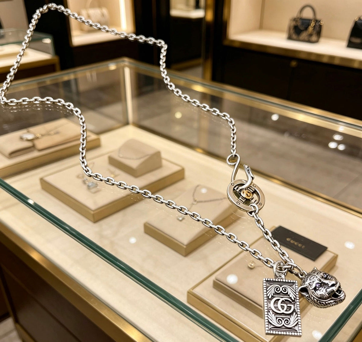 Martin Graham pendant necklace in polished metal-tone – close-up detail