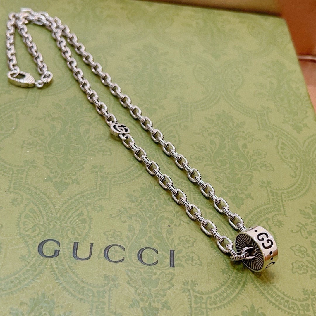 Martin Graham pendant necklace in polished metal-tone – close-up detail