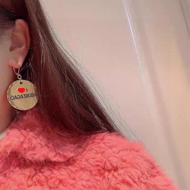 Martin Graham earrings in polished metal-tone – front product view