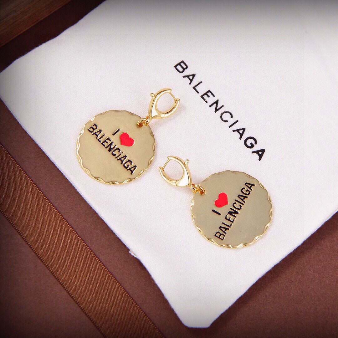 Martin Graham earrings in polished metal-tone – close-up detail