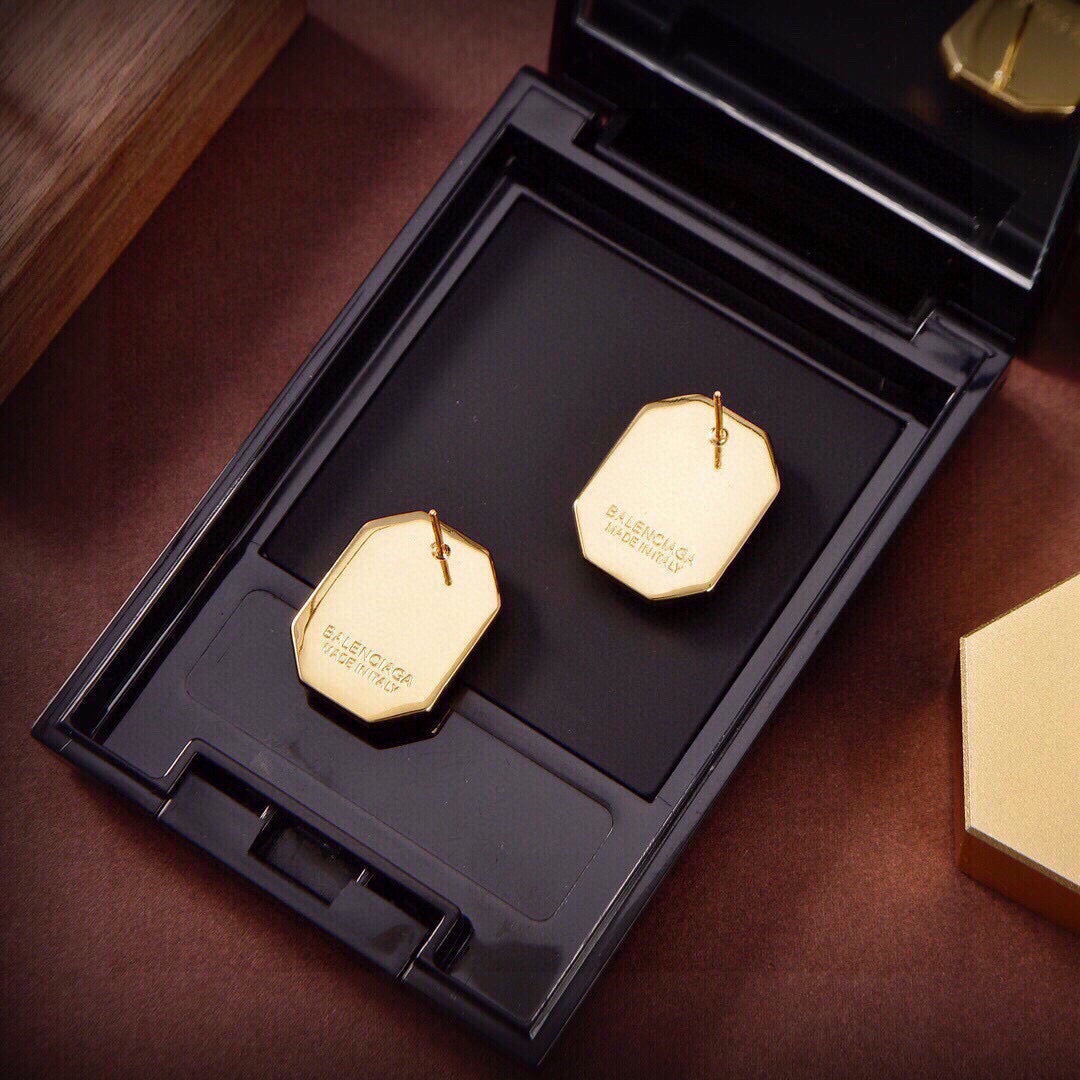 Martin Graham stud earrings in polished metal-tone – close-up detail