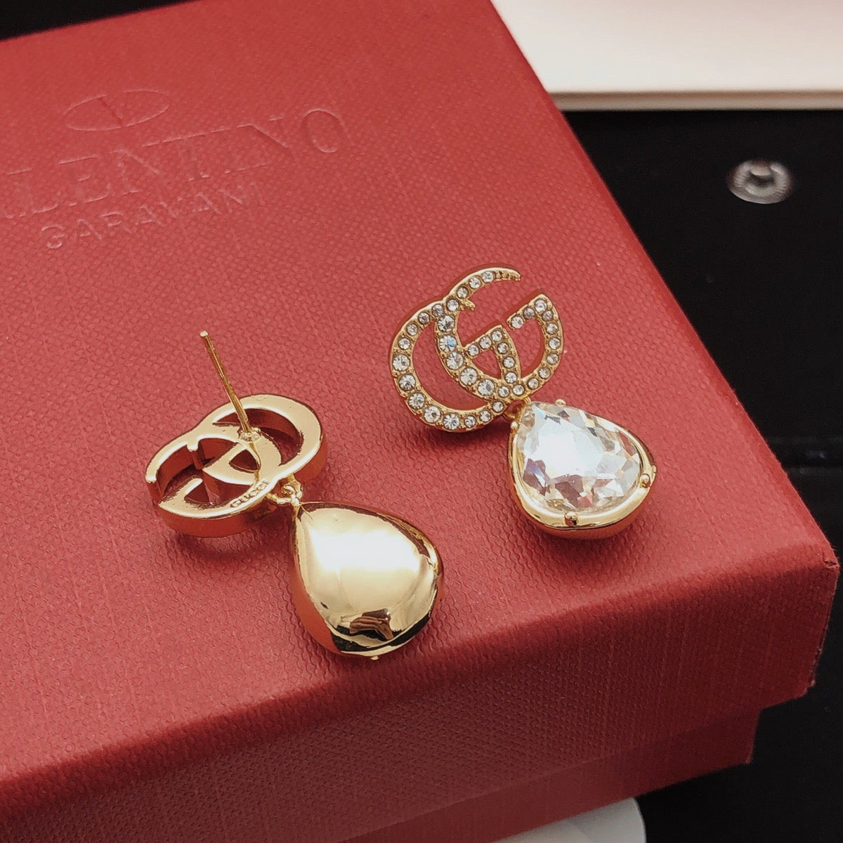 Martin Graham stud earrings in polished metal-tone – close-up detail