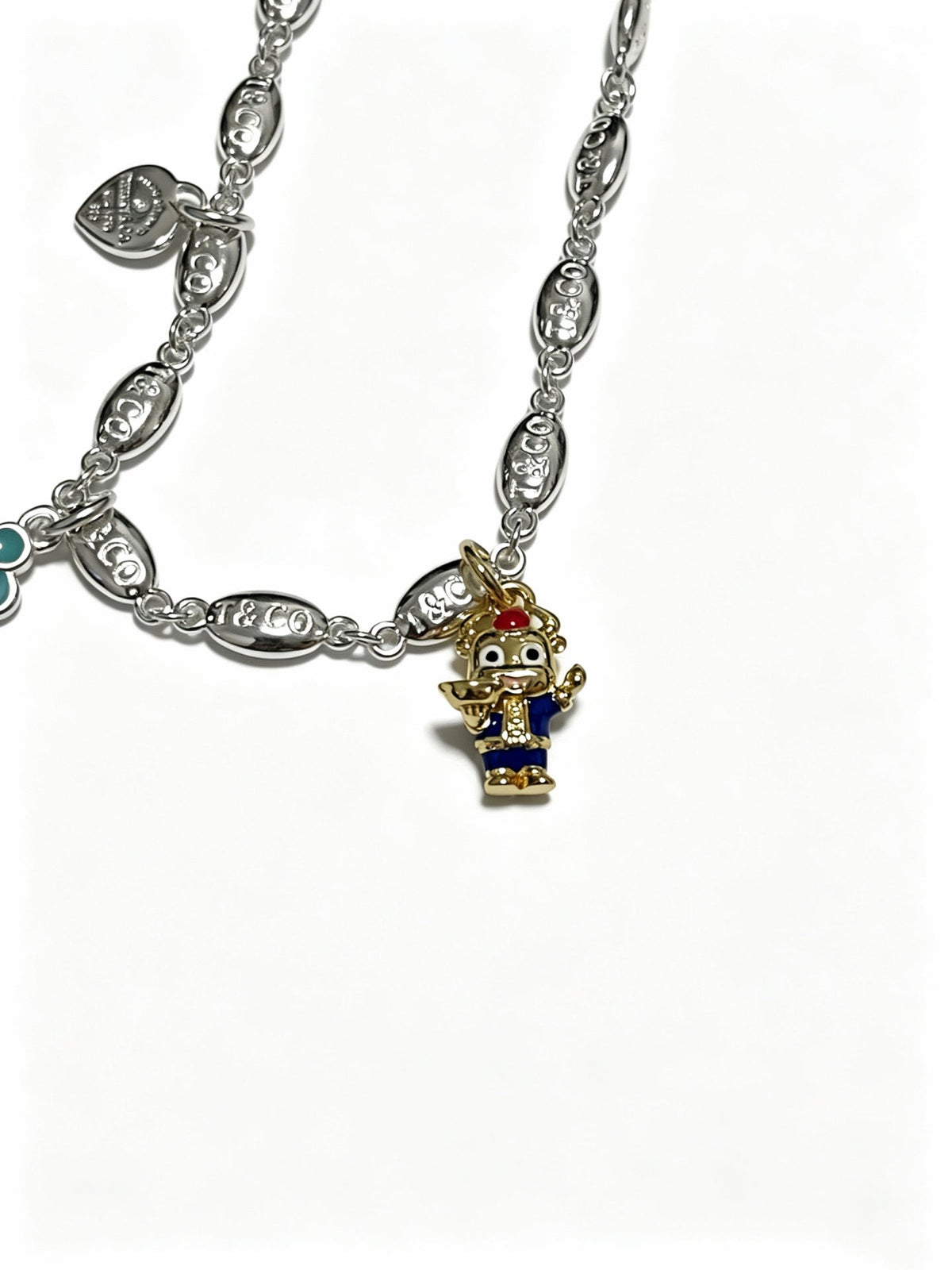 Martin Graham pendant necklace in polished metal-tone – side detail